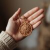 Hand holding a cute handmade crochet keychain toy.